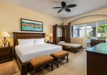 Spacious master bedroom with king bed, daybed, and balcony.