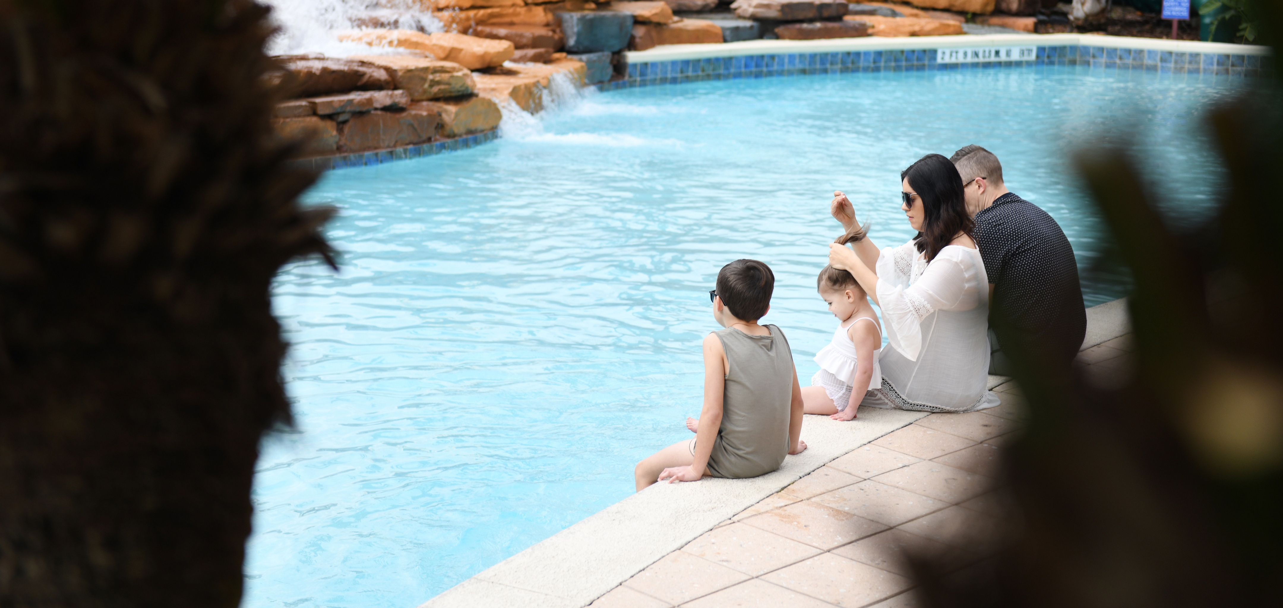 Family sitting near the pool at Orange Lake Resort in Orlando, FL