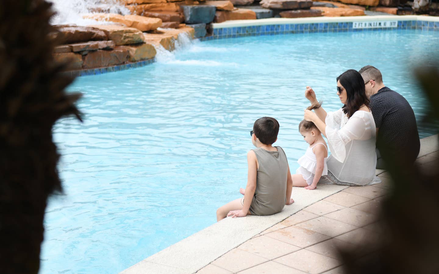 Family sitting near the pool at Orange Lake Resort in Orlando, FL