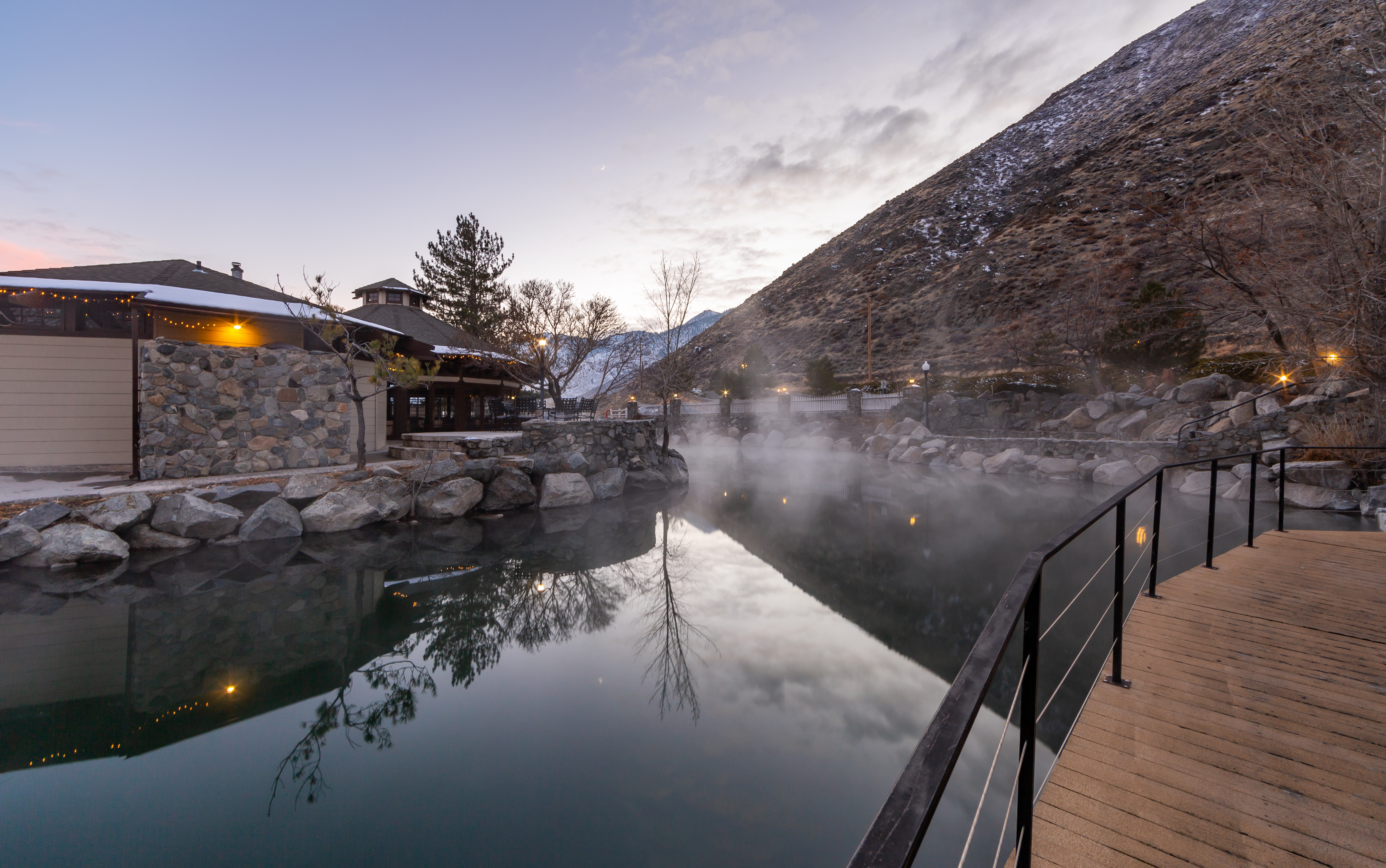 Bridge overlooking a lake and a view of the Sierra Nevada Mountains at David Walley's Resort in Genoa, Nevada