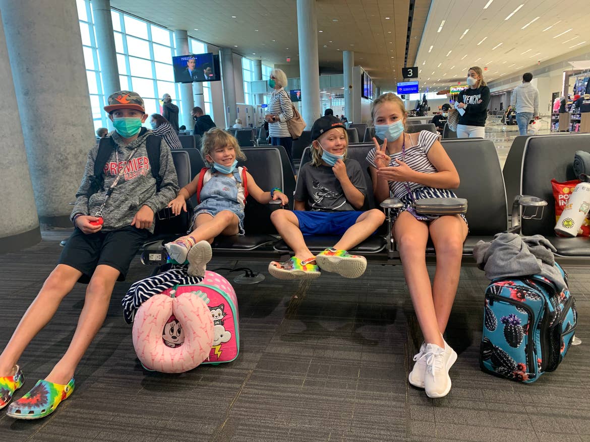 Ashley's kids posing in the terminal