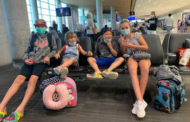 Ashley's kids posing in the airport terminal.
