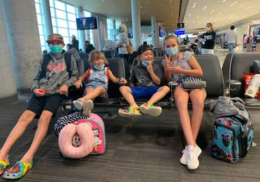 Ashley's kids posing in the airport terminal.