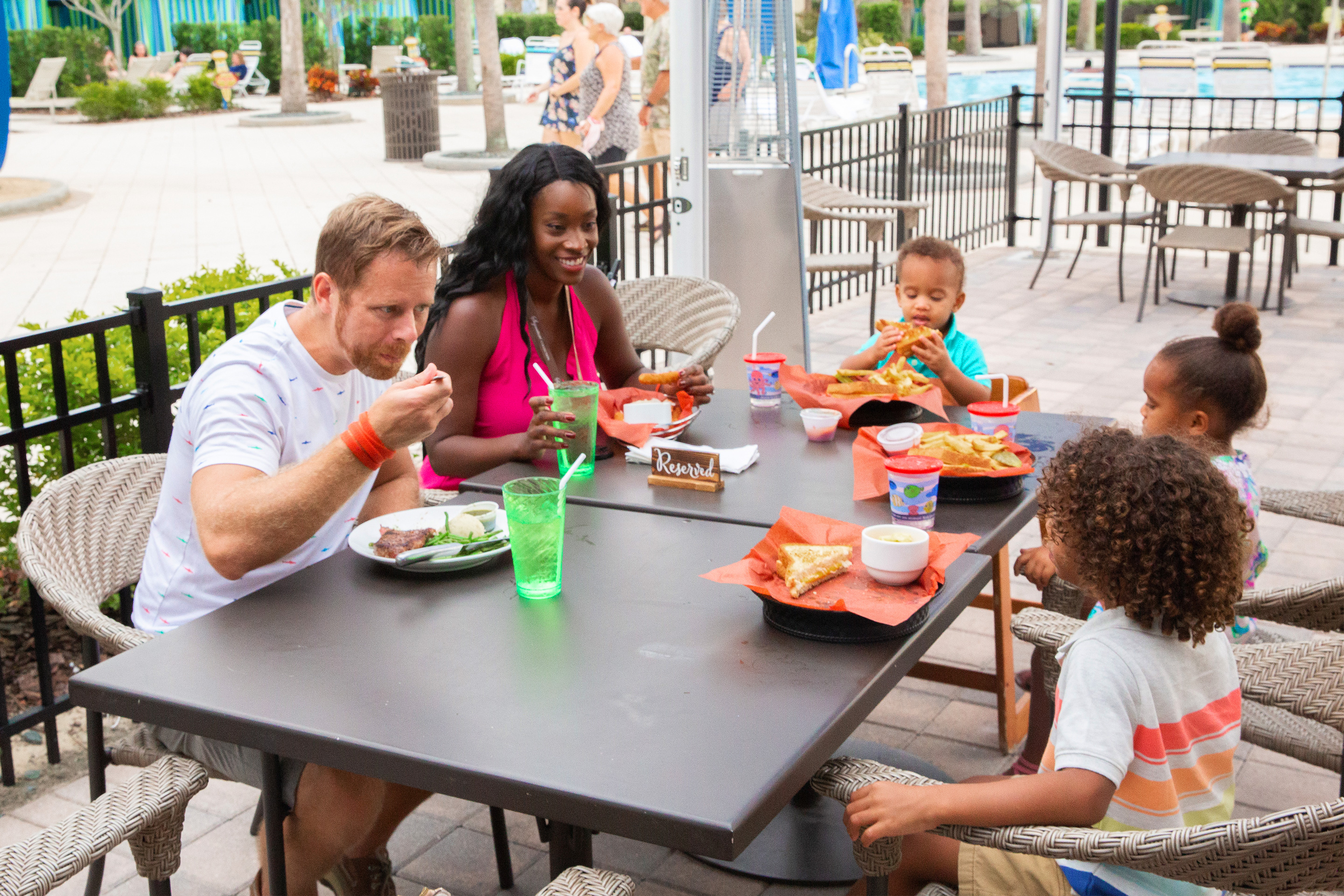 Featured Contributor, Sally Butan (back-left) and her family of five enjoy some beverages at a table at Breezes at our Orange Lake resort located near Orlando, FL.