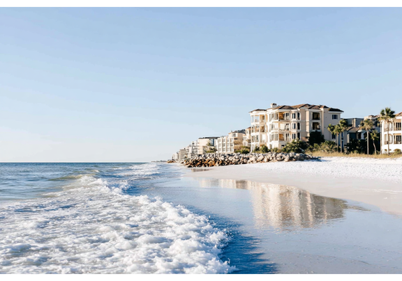 Peaceful shoreline view of a Florida beach with gentle waves and soft sand.