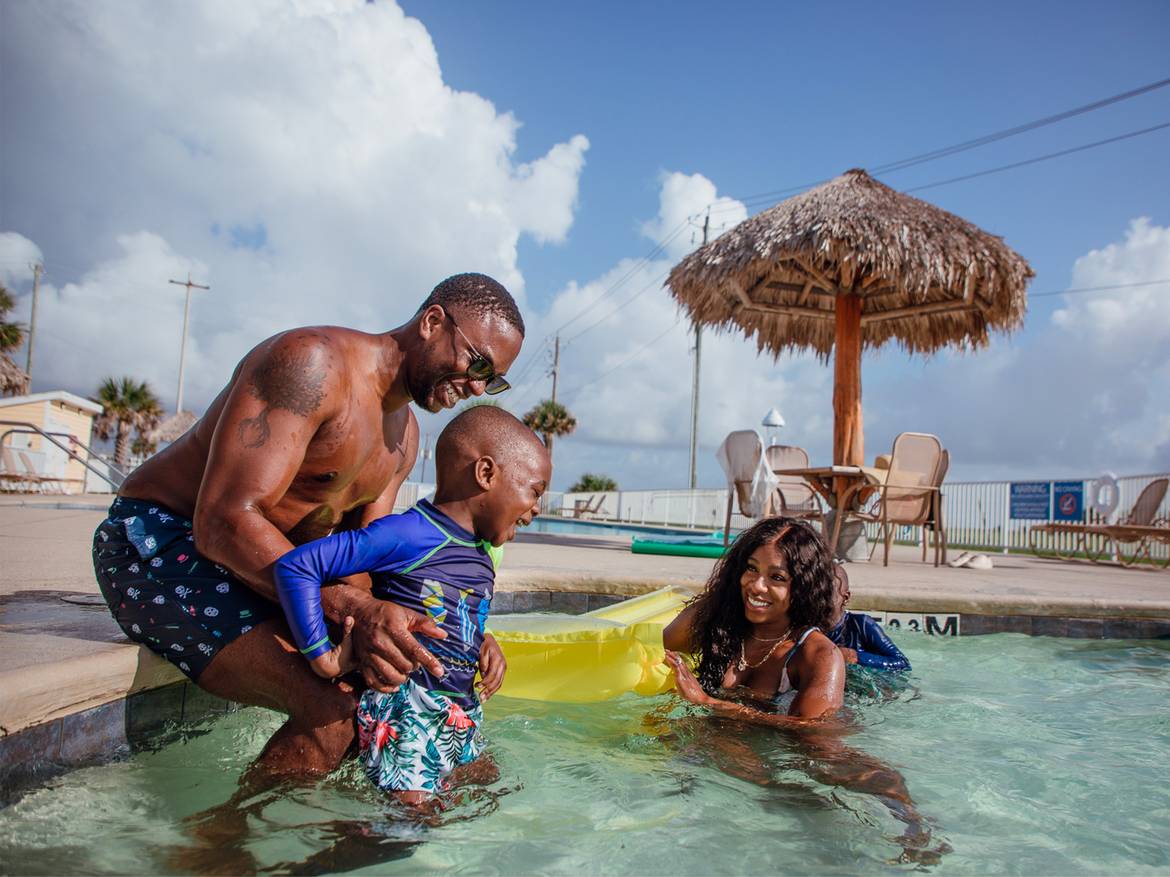 Family playing in pool