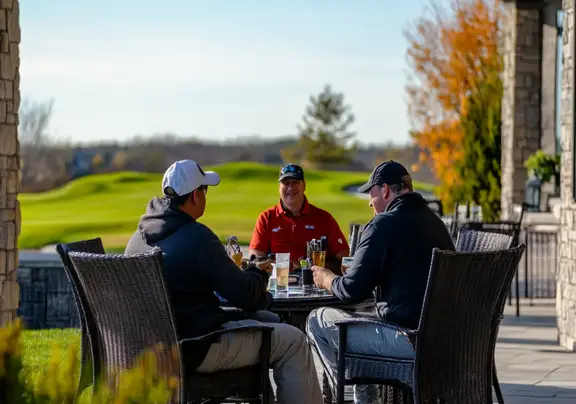 A group of golfers enjoying a drink on the patio Scottsdale AZ resort.