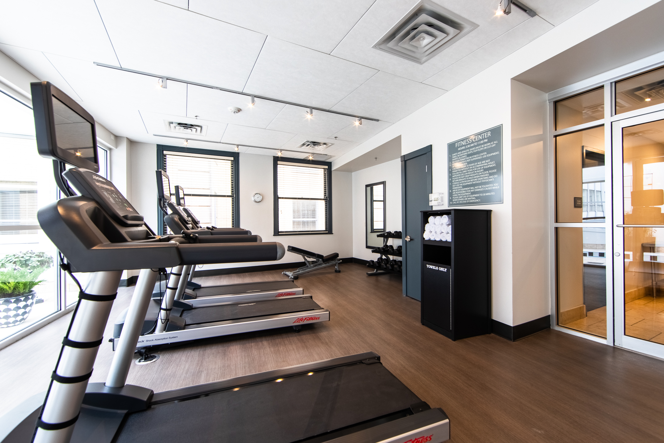 Fitness center with treadmills, free weights and towels at New Orleans Resort in Louisiana.