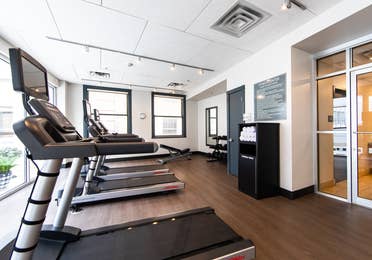 Fitness center with treadmills, free weights and towels at New Orleans Resort in Louisiana.