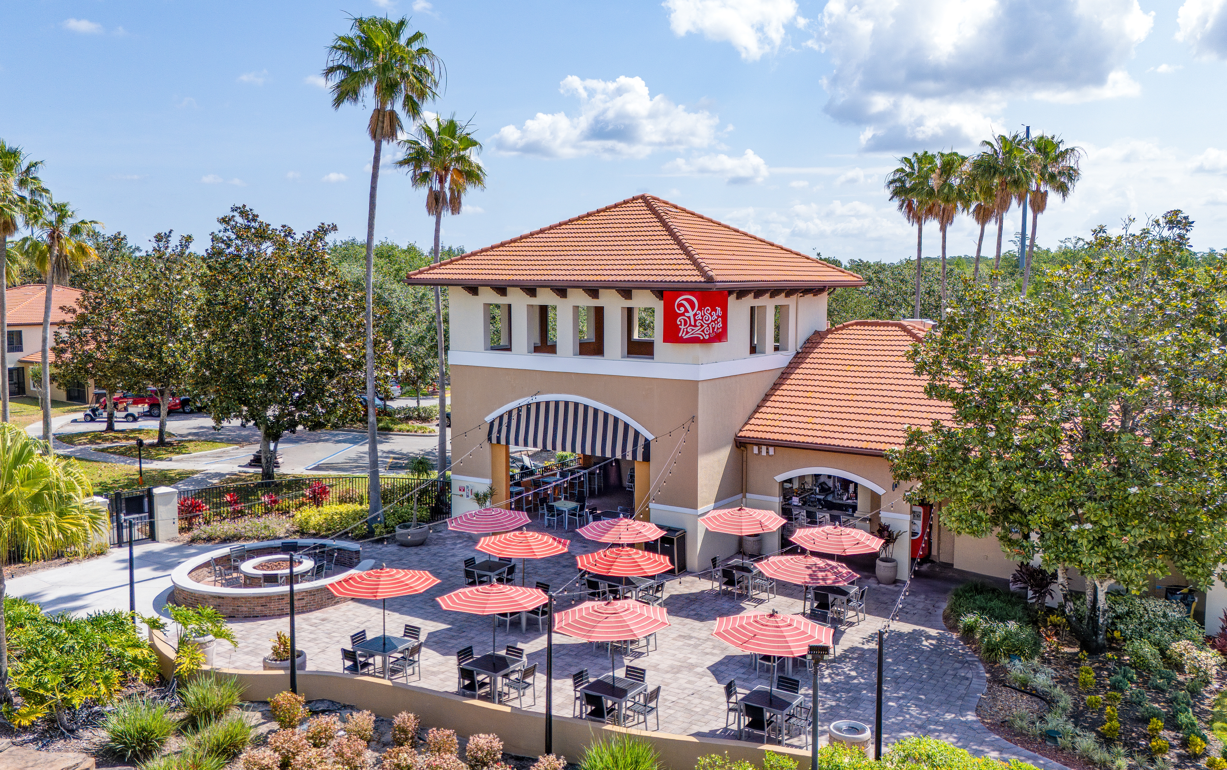 A group of people eating outside of Paisan Pizzeria at Orange Lake Resort near Orlando, Florida.