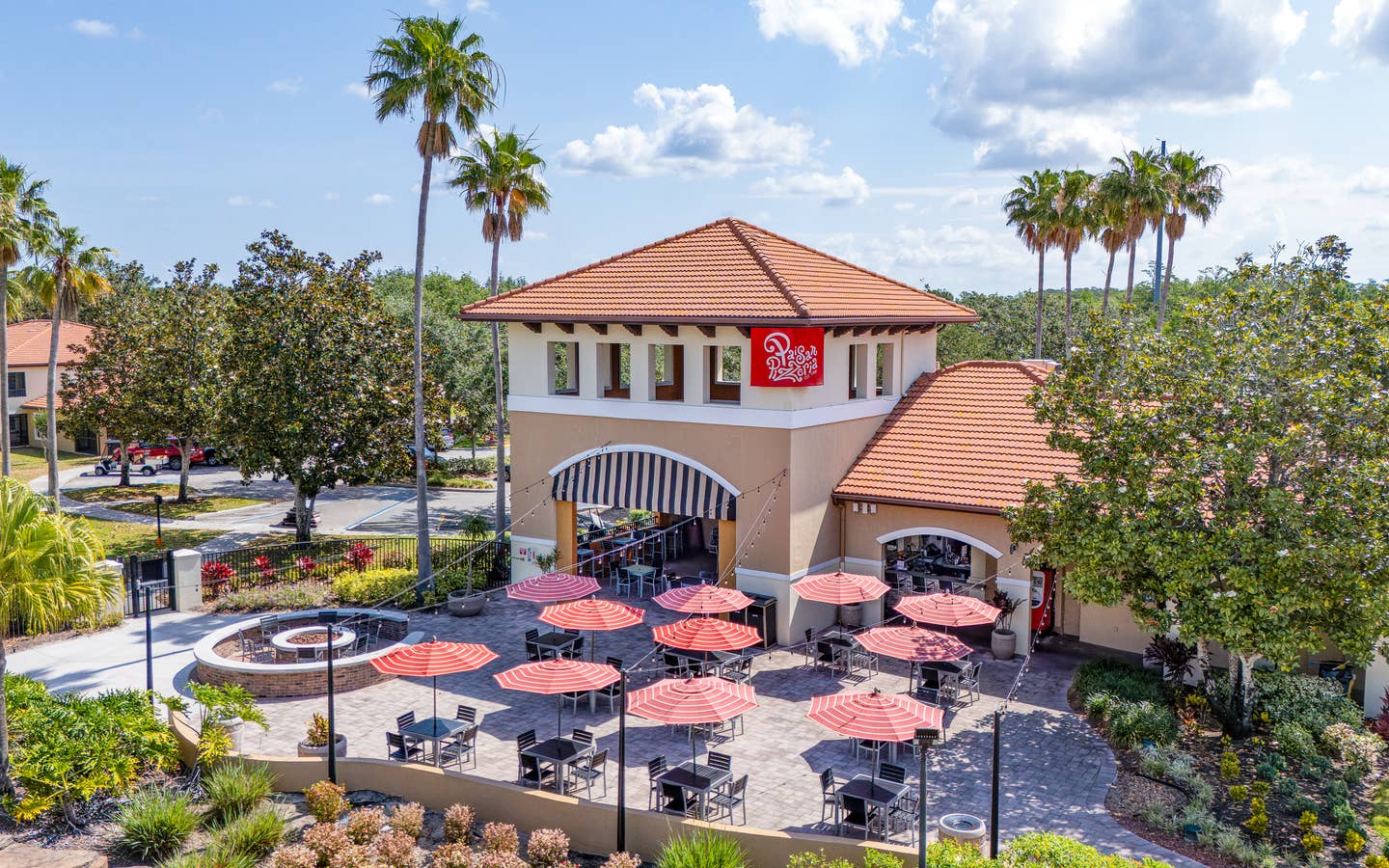 A group of people eating outside of Paisan Pizzeria at Orange Lake Resort near Orlando, Florida.