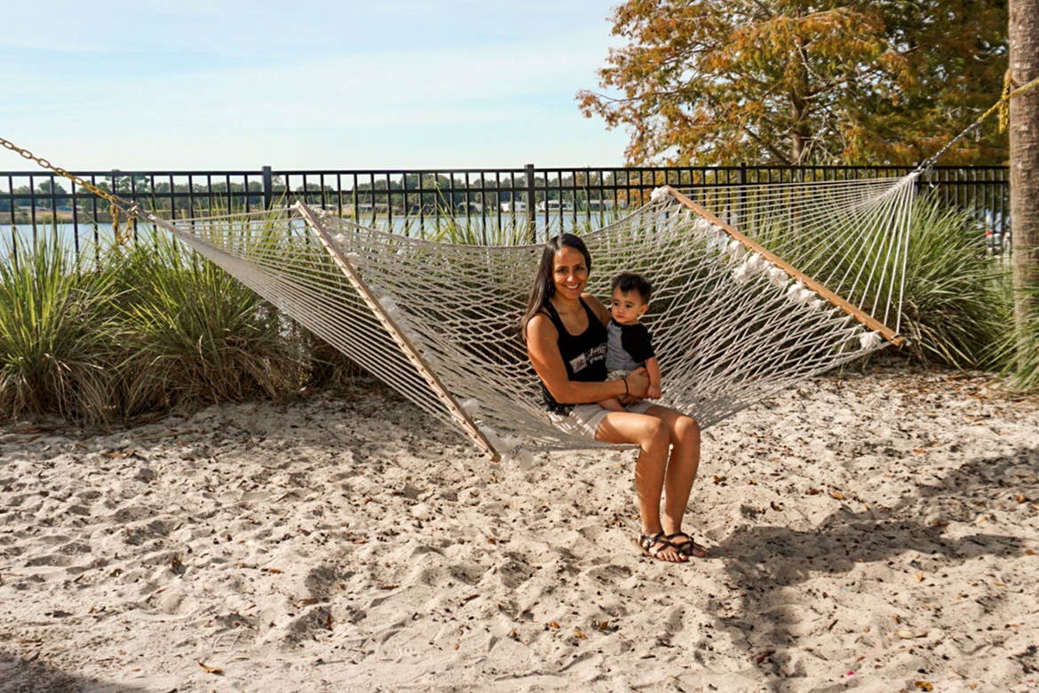 Author, Danny Pitaluga's wife, Val (left), and son, Joey (right), sit on a hammock near a waterfront at our Orange Lake Resort in Orlando, Florida.
