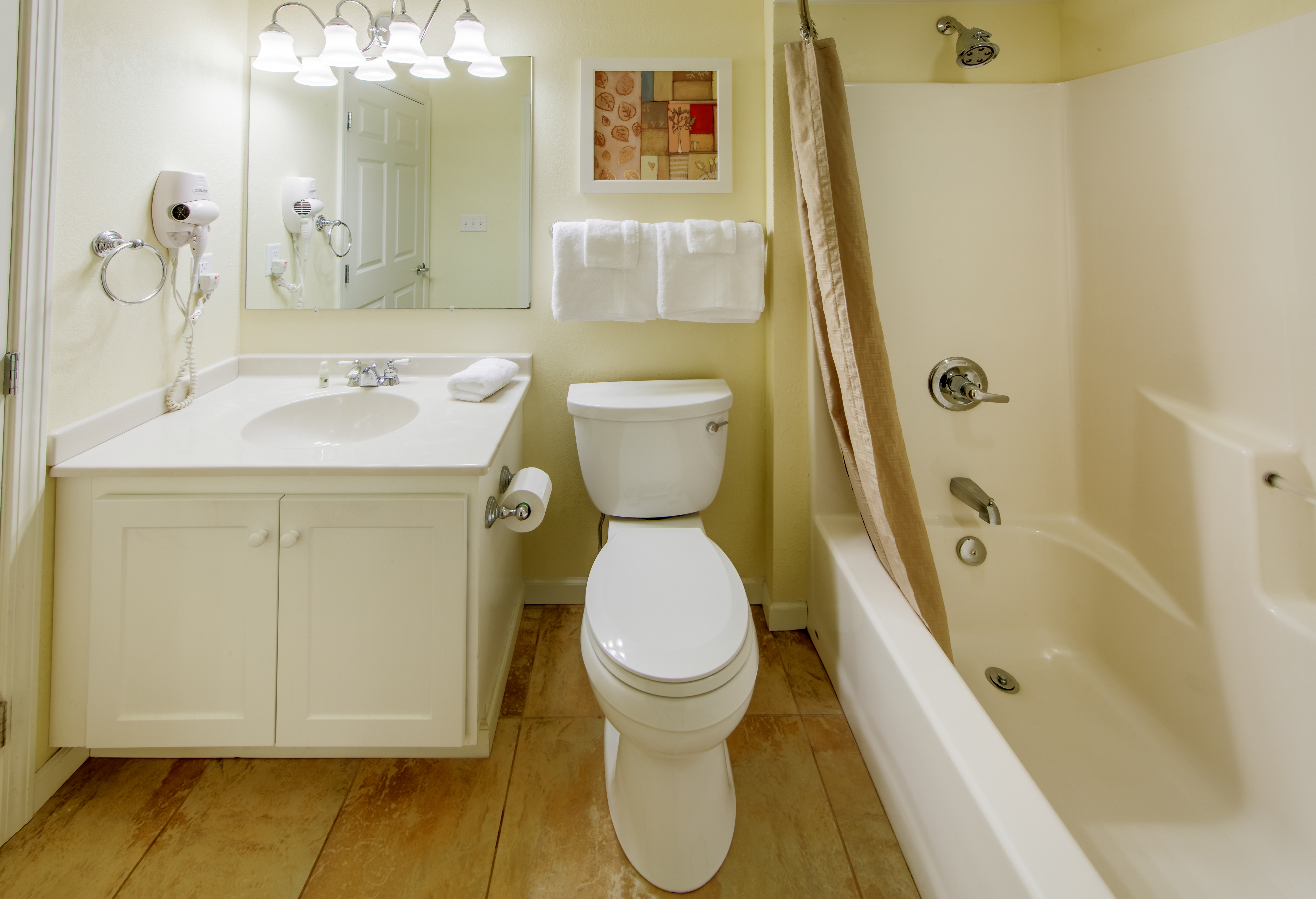 Bathroom with vanity, toilet, and tub in a villa at Oak n' Spruce Resort in South Lee, Massachusetts