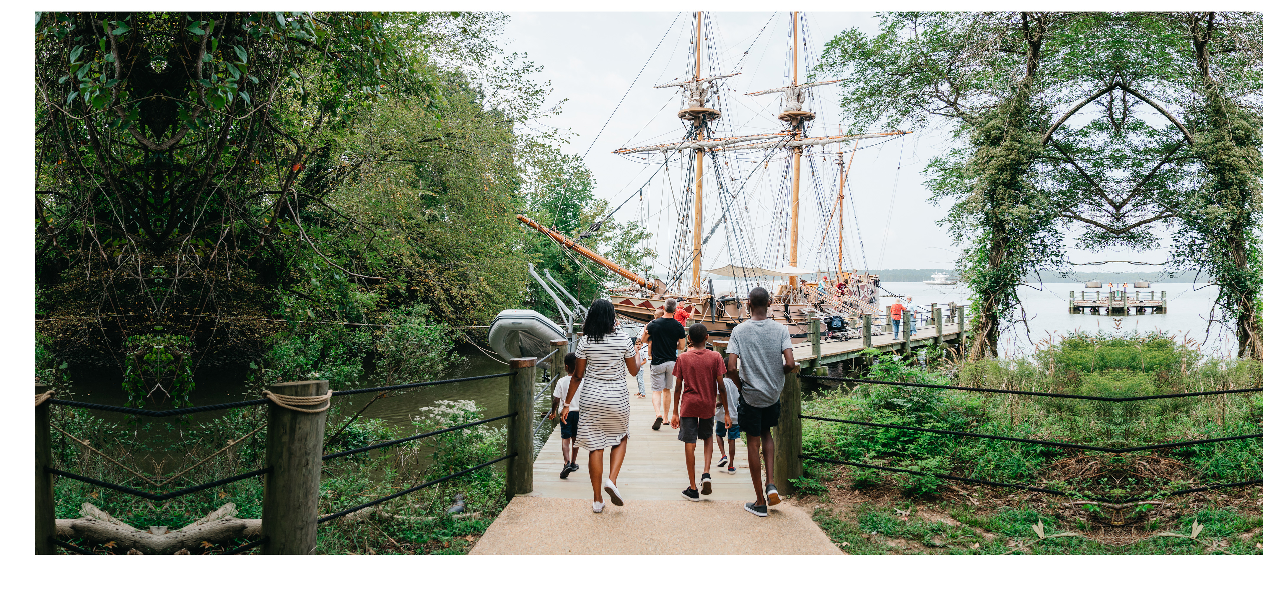 A family walks towards the Susan Constant ship at Jamestown Settlement in Williamsburg, Virginia.
