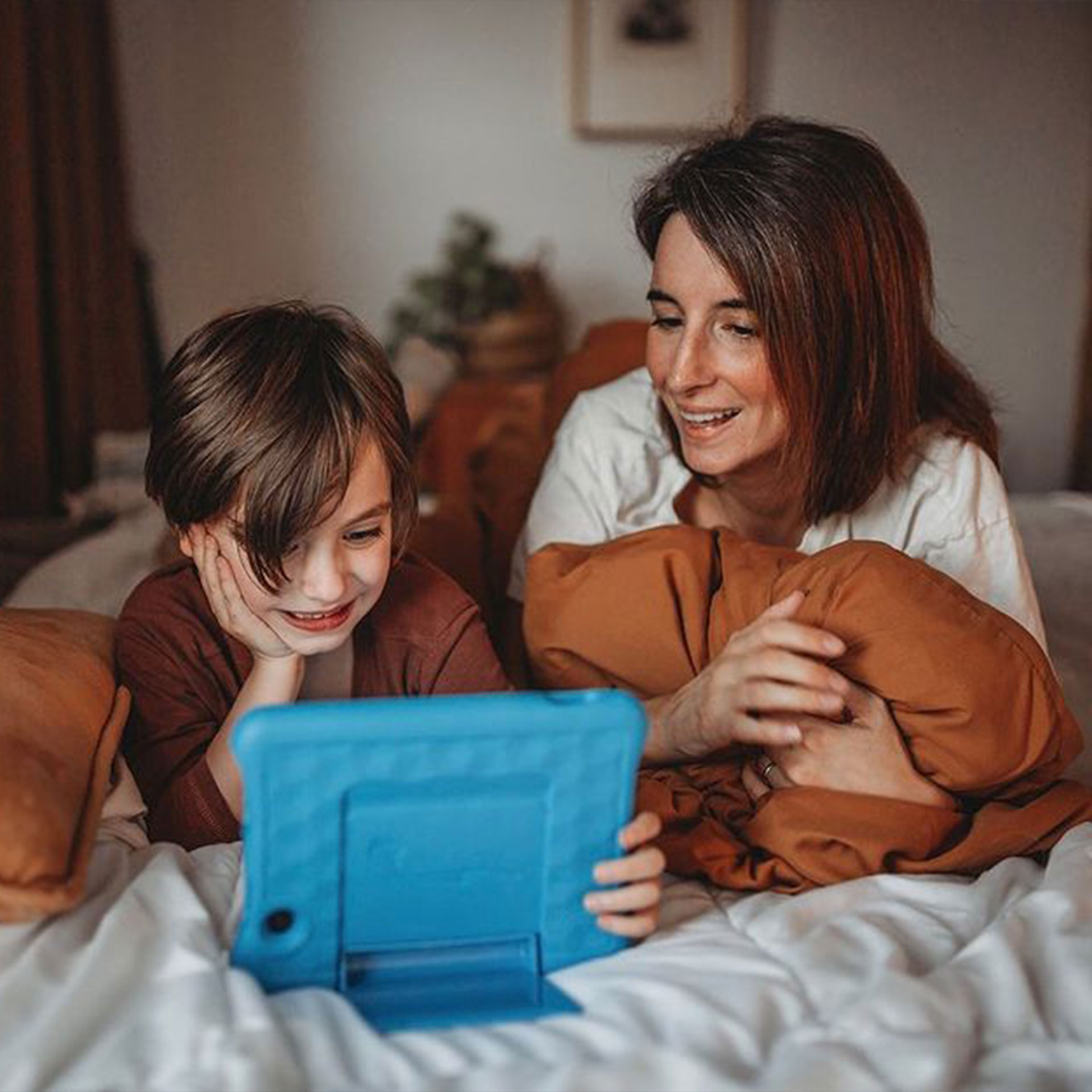 Featured Contributor, Eileen Lamb's son sits alongside her watching a tablet.