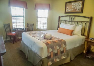 Bedroom with sitting area in a two-bedroom villa at the Holiday Hills Resort in Branson Missouri.