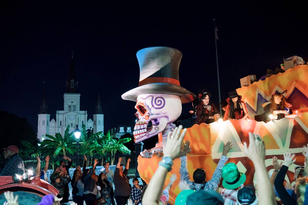 A parade float passes Jackson Square at night.