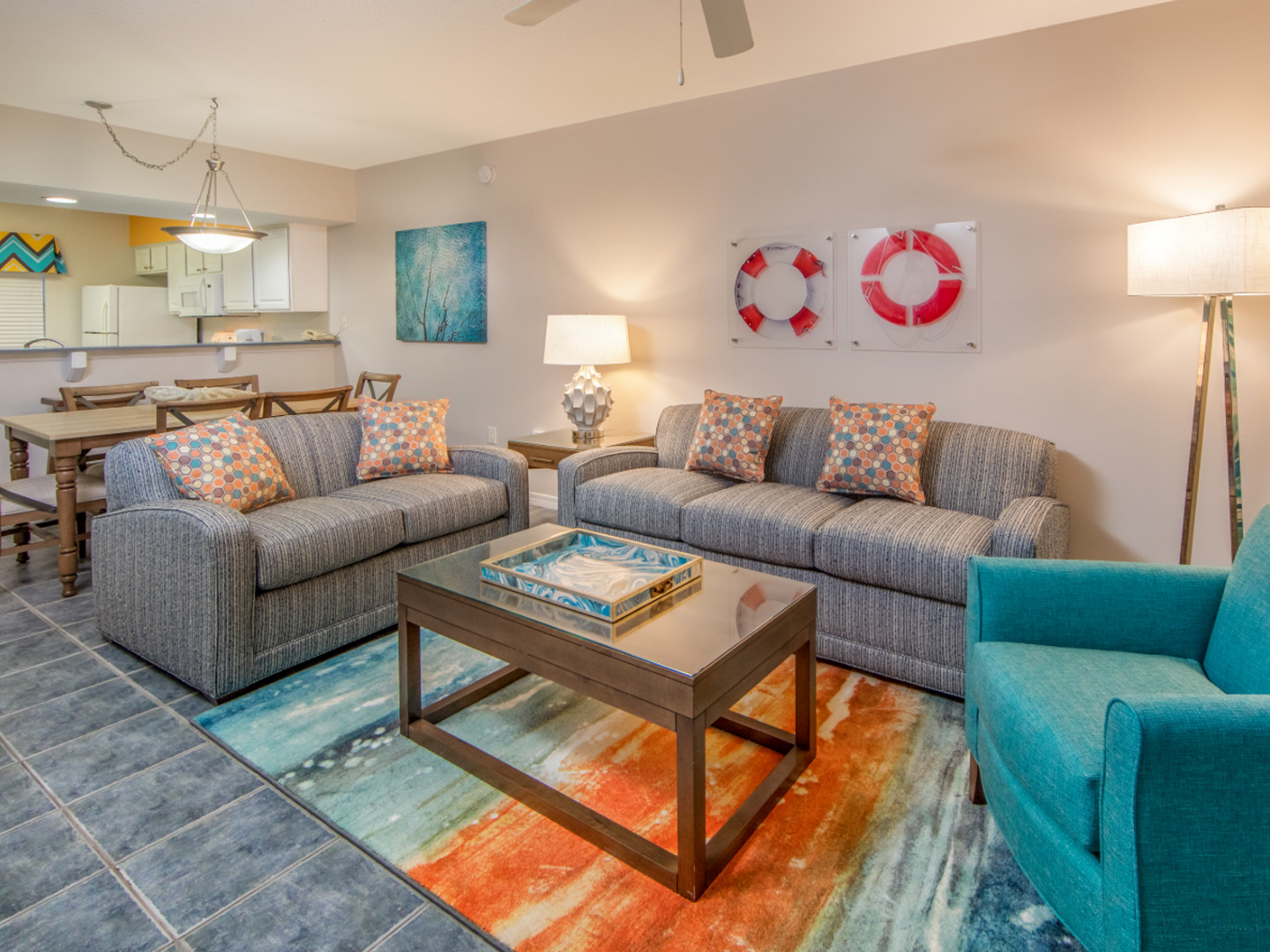 Living room with two couches, an accent chair, and coastal decor in a two-bedroom villa at Panama City Beach Resort