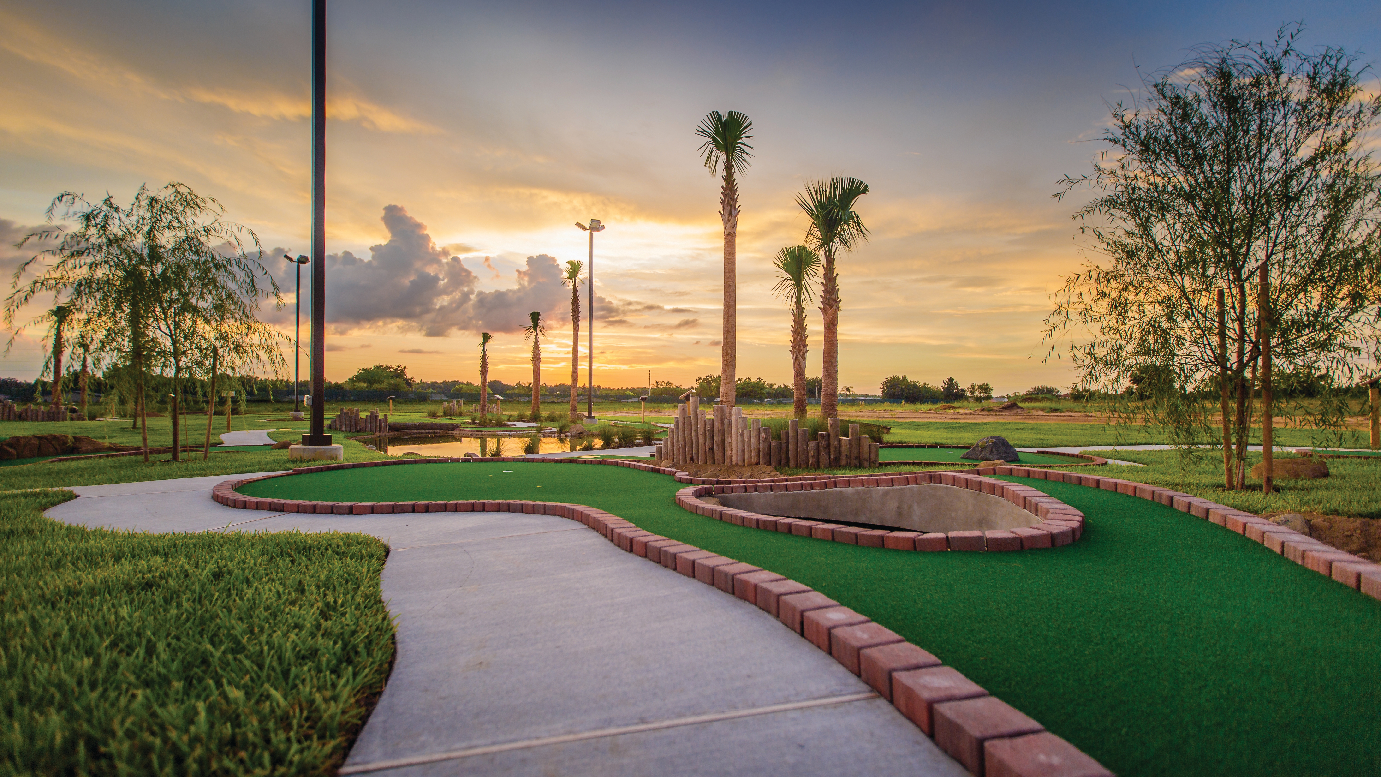 Outdoor mini golf course at sunset at Orlando Breeze Resort in Florida.