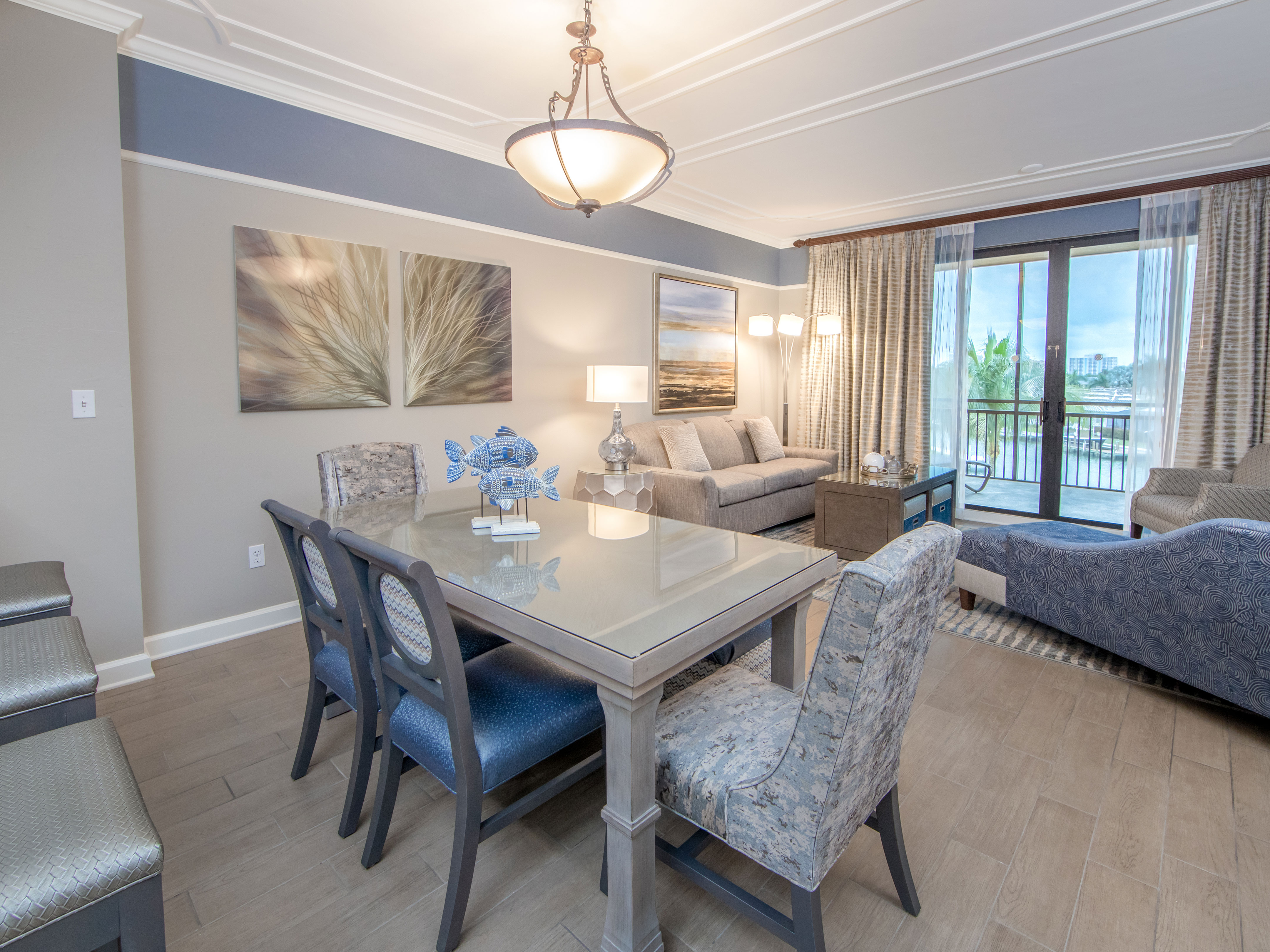 Dining room table with six chairs and coastal decor in a three-bedroom villa at Sunset Cove Resort in Marco Island, Florida
