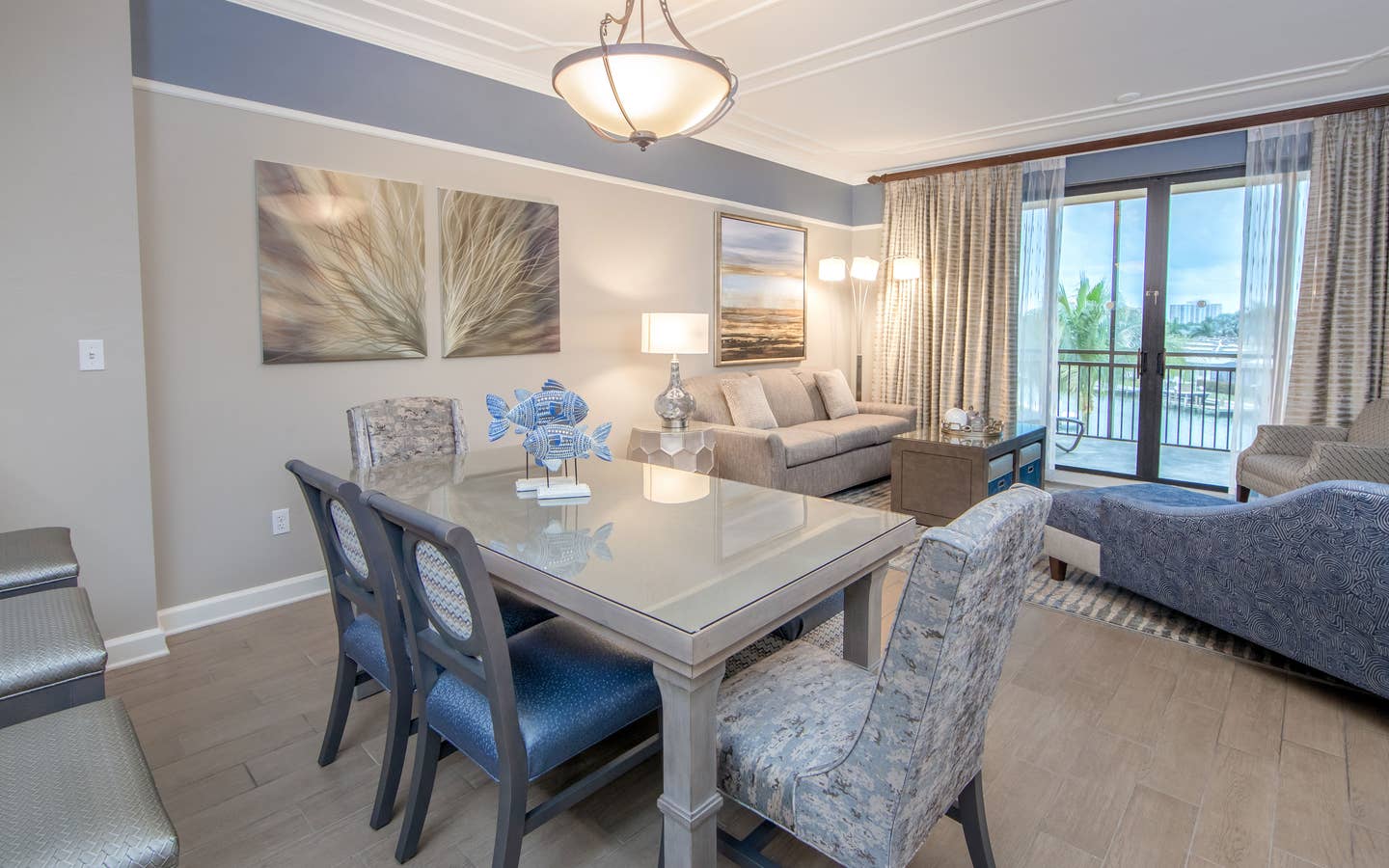 Dining room table with six chairs and coastal decor in a three-bedroom villa at Sunset Cove Resort in Marco Island, Florida