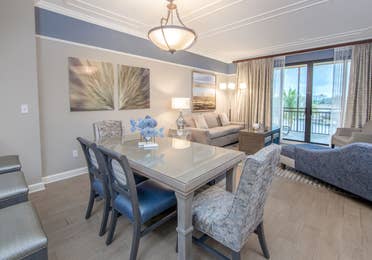 Dining room table with six chairs and coastal decor in a three-bedroom villa at Sunset Cove Resort in Marco Island, Florida