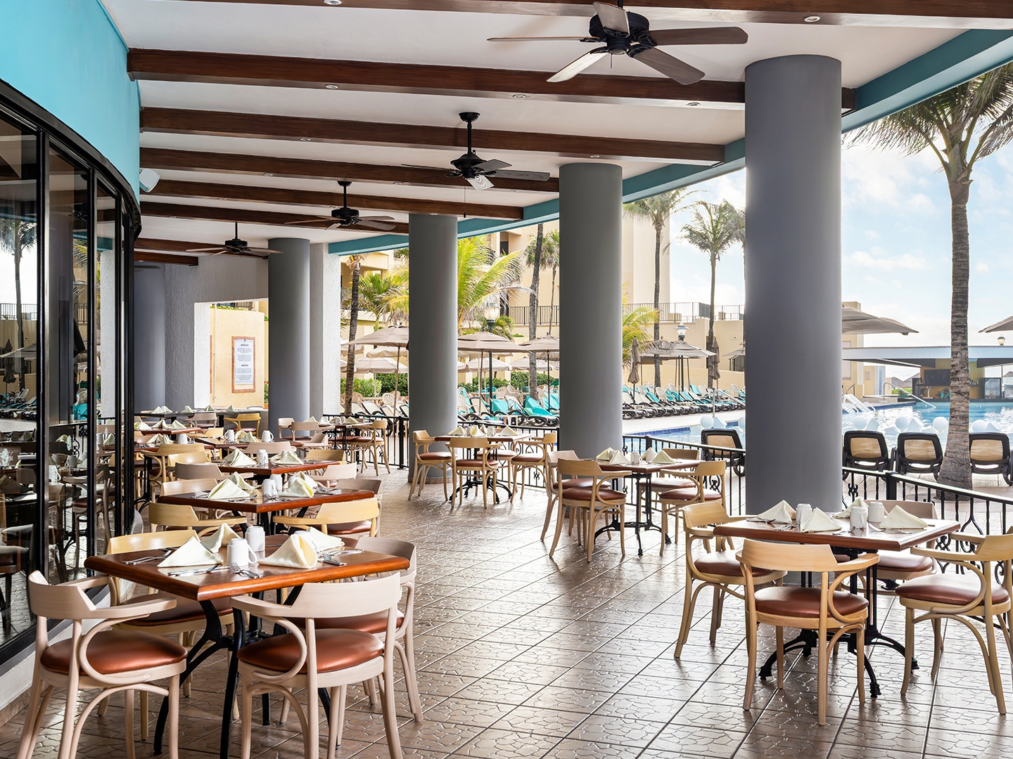 Poolside dining in a breezy, open-air setting.