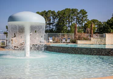 Shower umbrella in outdoor Beach Club pool at Villages Resort in Flint, Texas
