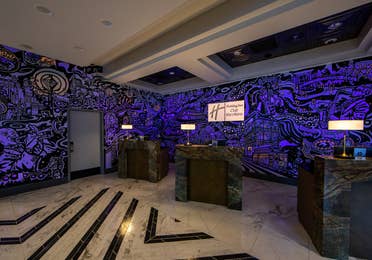 Front desk with mural at New Orleans Resort in Louisiana.