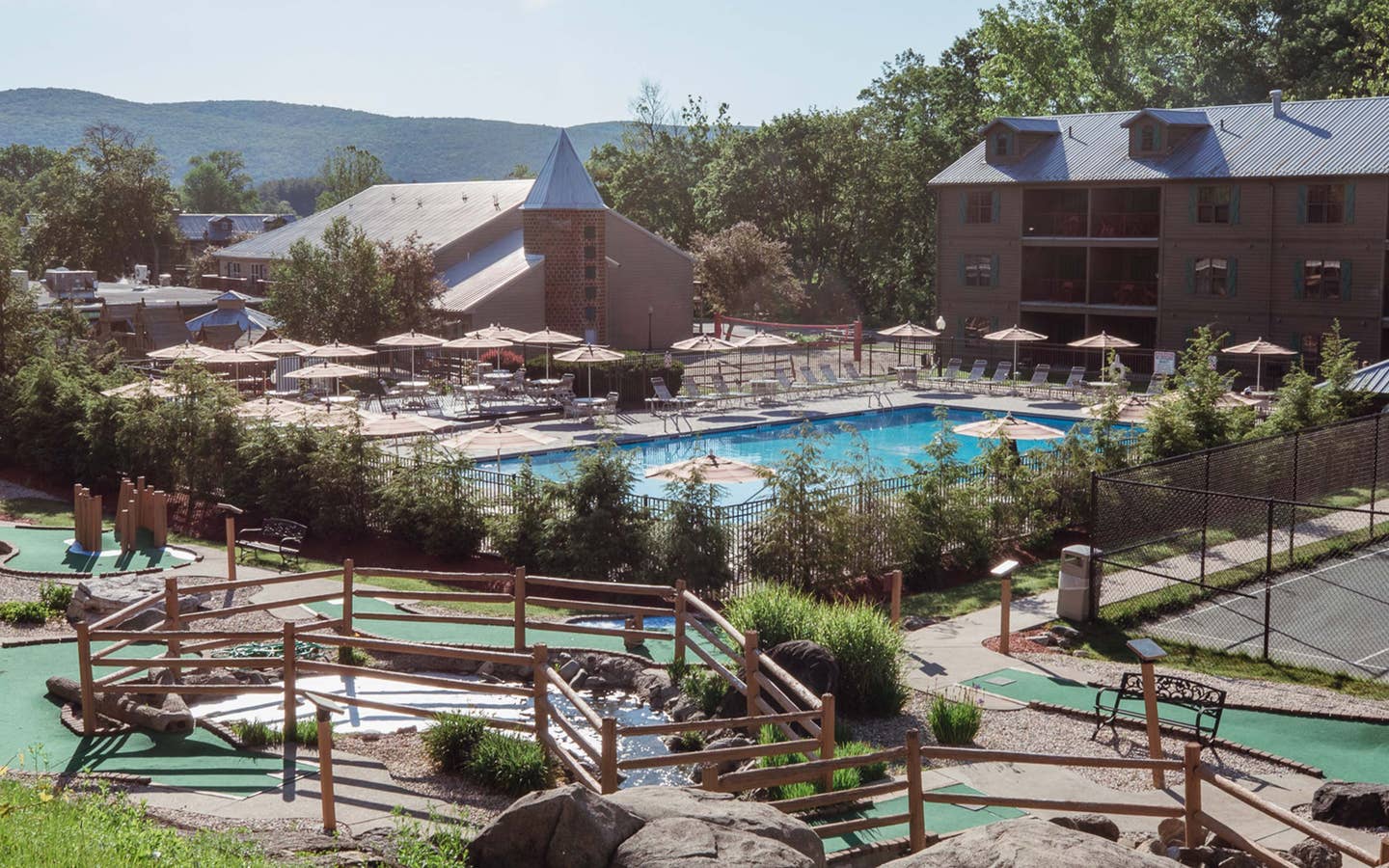 Property shot of Oak n' Spruce Resort with an outdoor pool, mini golf course and property building in South Lee, Massachusetts.