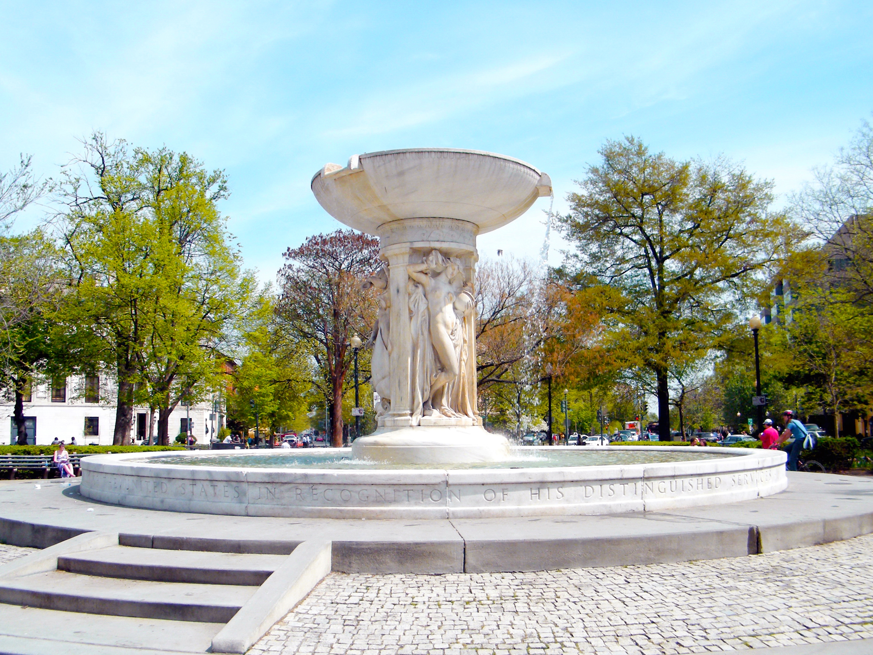  Dupont Circle fountain surrounded by trees, streets and neighborhood buildings in Washington, D.C. 