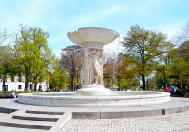 Dupont Circle fountain surrounded by trees, streets and neighborhood buildings in Washington, D.C.