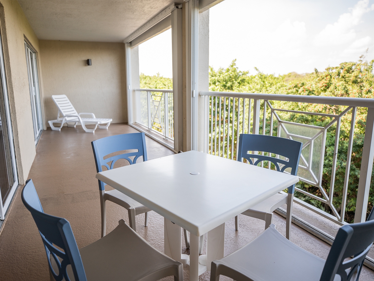 Balcony with outdoor table and chairs in a two-bedroom villa at Cape Canaveral Beach Resort.