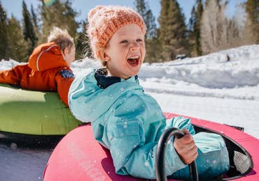 children snow tubing at Ski Butternut near Oak n' Spruce Resort in South Lee, MA.
