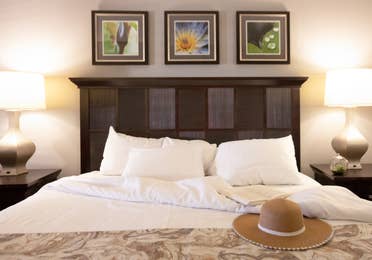 Closeup of sun hat sitting on bed in a villa in East Village at Orange Lake Resort near Orlando, Florida