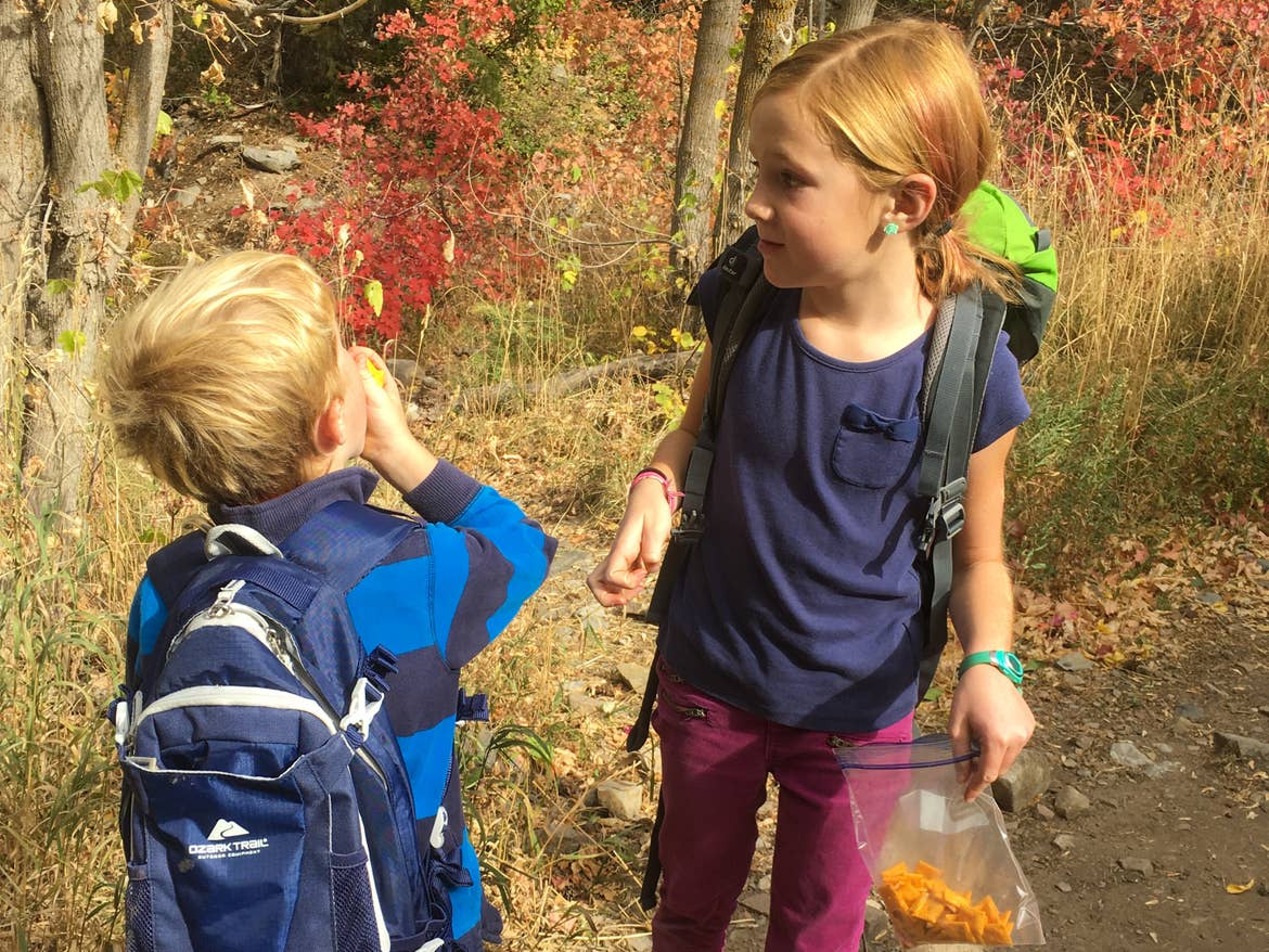 Jessica's daughter and son stopping for a break to eat snacks on their hike