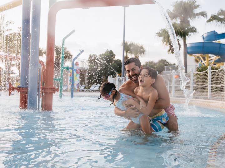 Dad with kids in pool at Cape Canaveral Beach resort in Florida 