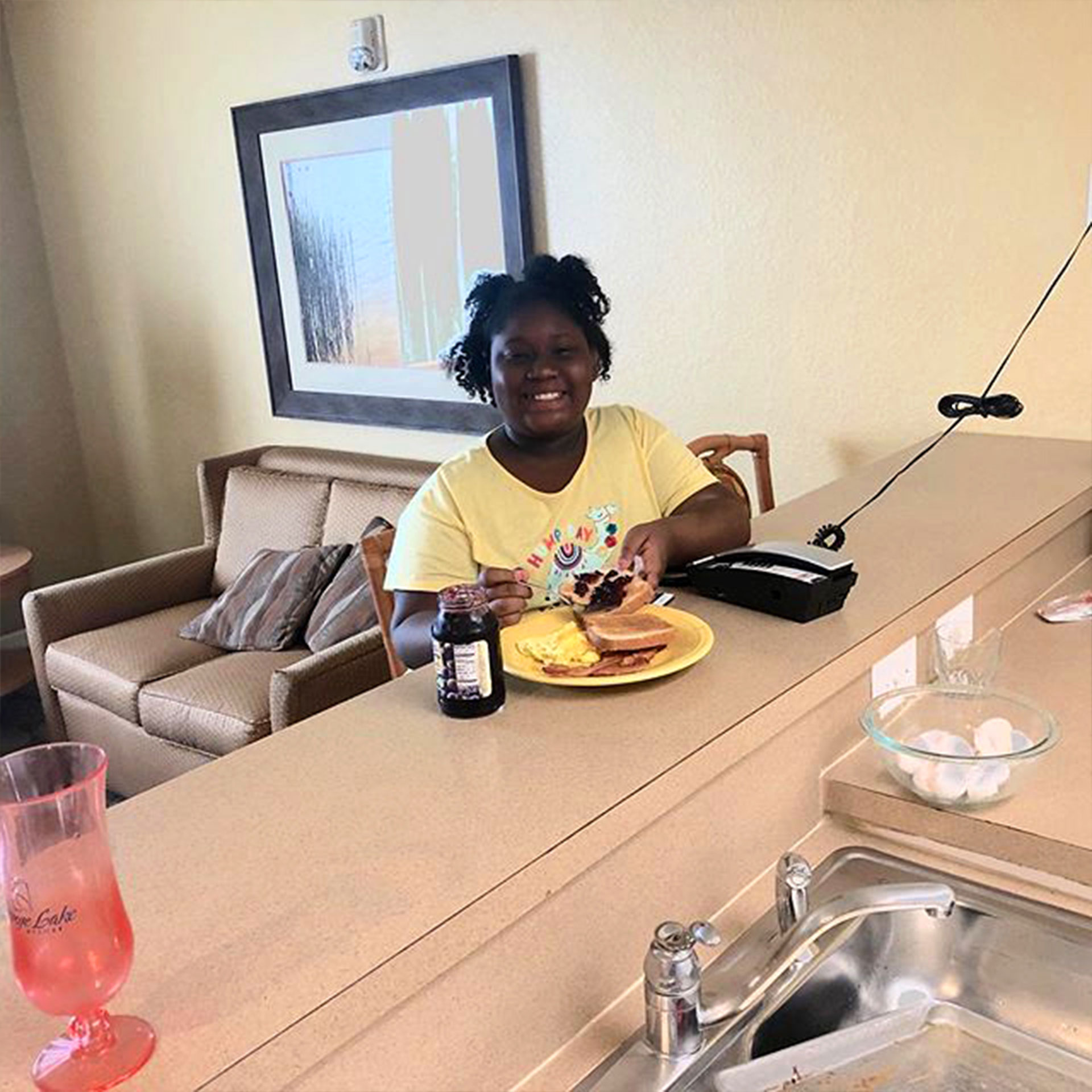 A guest enjoying breakfast at their kitchen countertop in our villa at Orange Lake Resort.