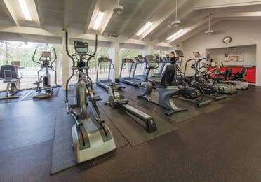 Fitness center with ellipticals and treadmills at Holly Lake Resort in Texas.