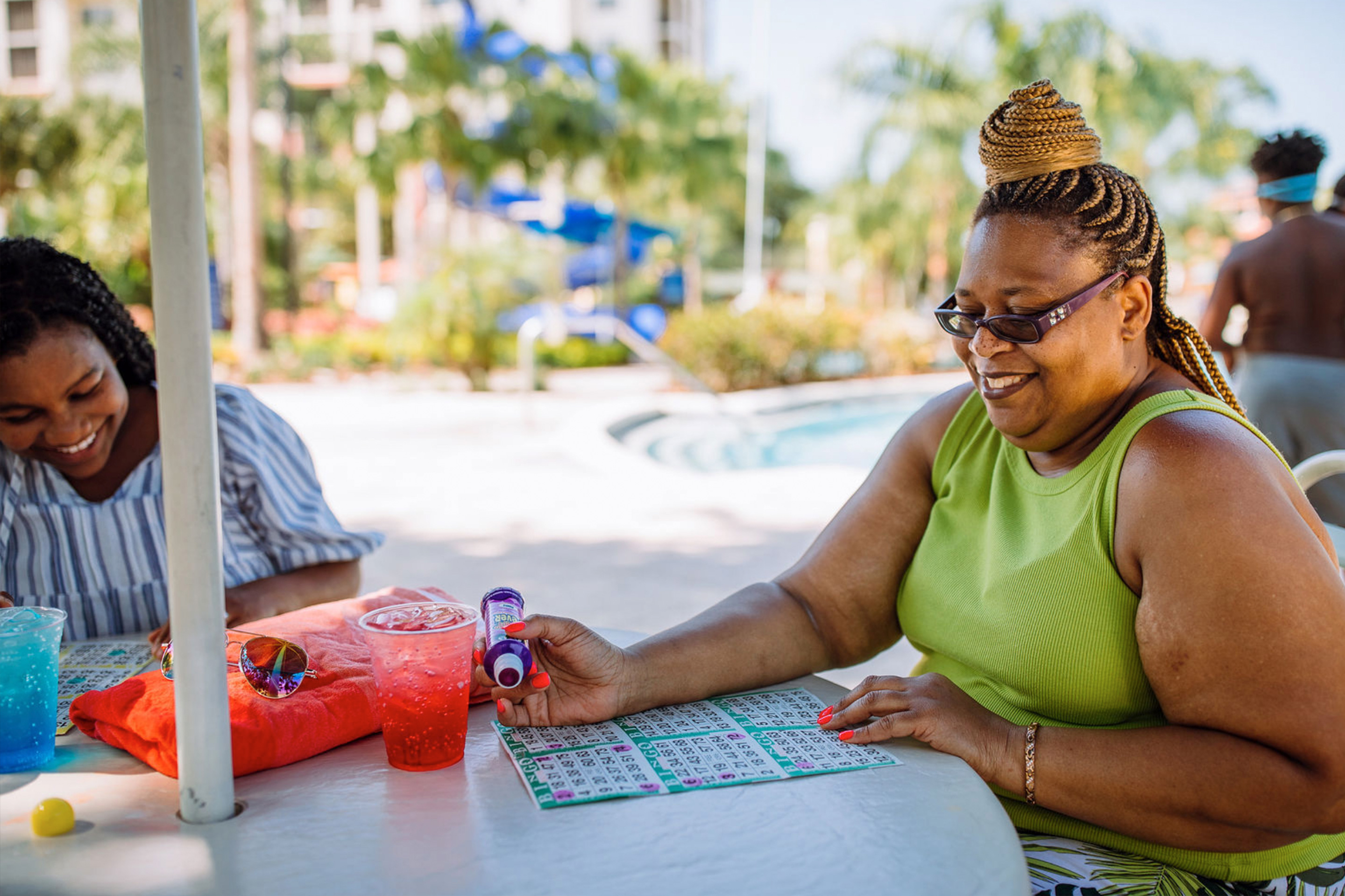 Krystin Godfrey (left) and her aunt (right) enjoy a round of bingo poolside in River Island at our Orange Lake Resort located in Orlando, FL.