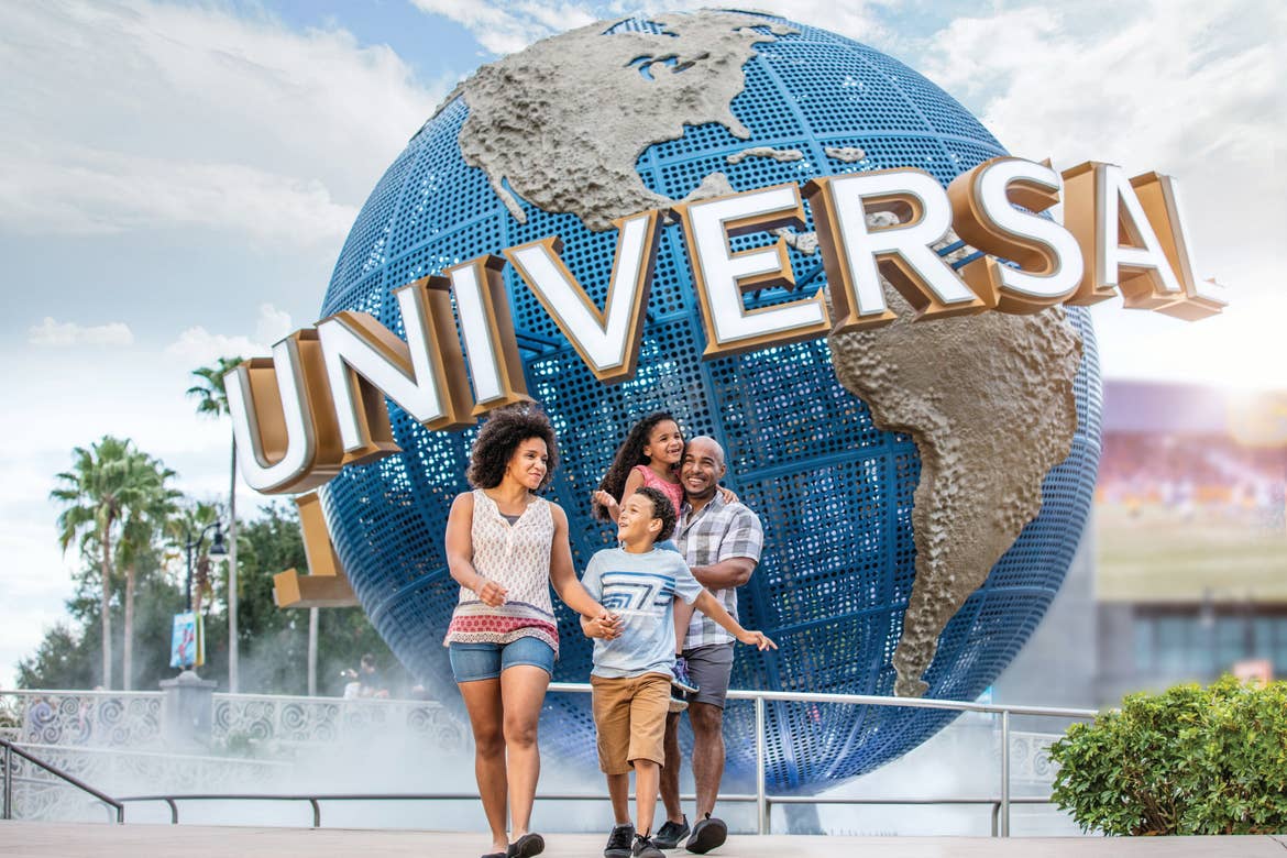 Family of four standing in front of the Universal Orlando globe