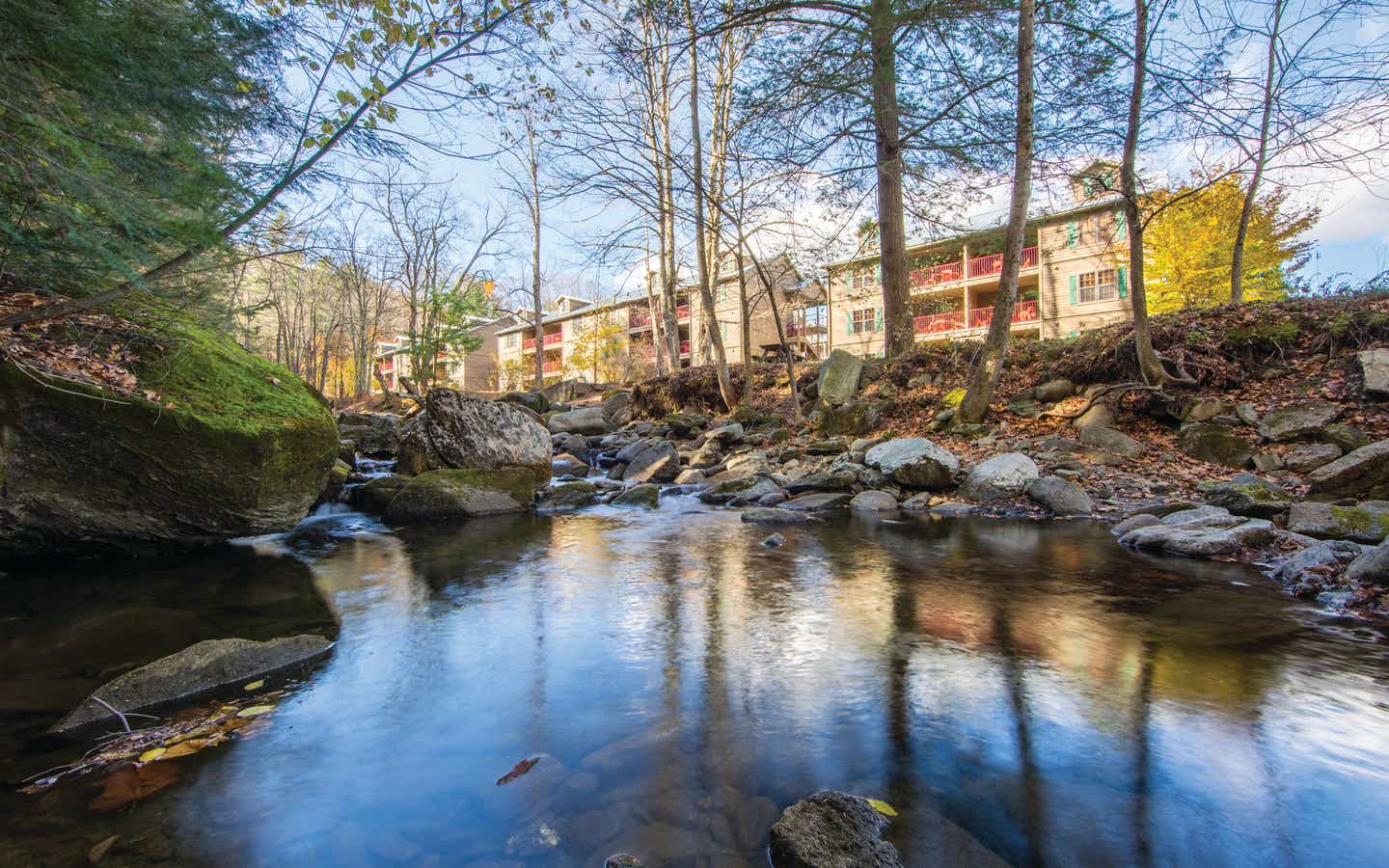 A creek lined with trees and running along the Oak n' Spruce Resort in South Lee, Massachusetts