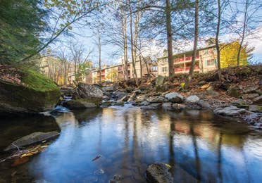 A creek lined with trees and running along the Oak n' Spruce Resort in South Lee, Massachusetts.