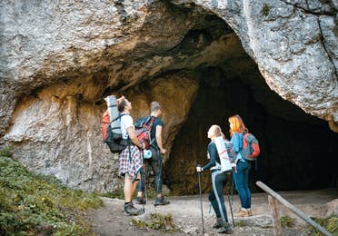 Group of hikers exploring a cave in the mountain