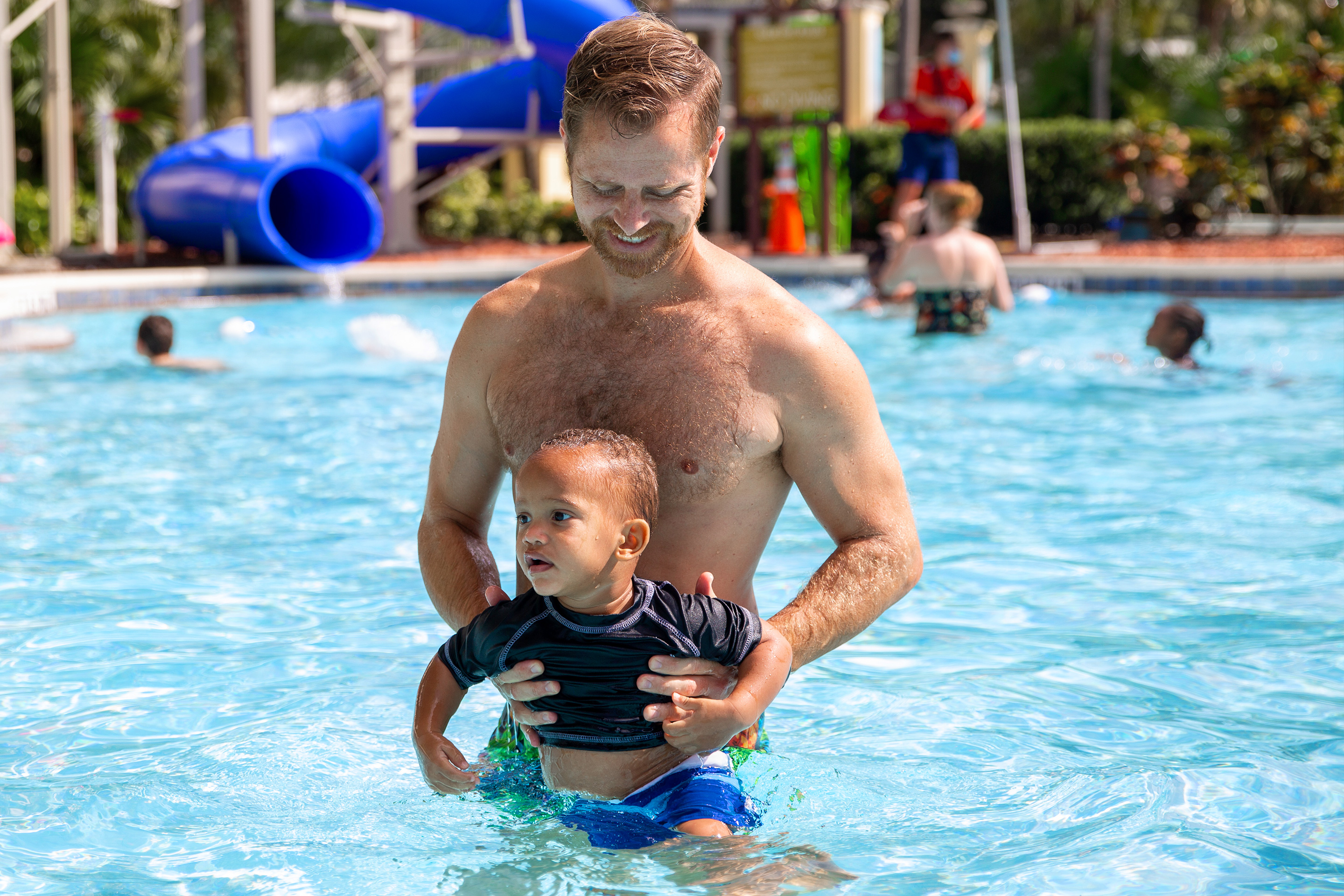 Featured Contributor, Sally Butan's husband holds their son, Alston, in the pool at our Orange Lake Resort located near Orlando, FL.