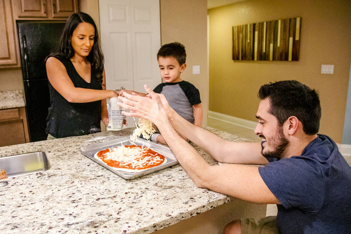 Author, Danny Pitaluga (right), his wife, Val (left) and son, Joey (middle), make a pizza together on the ADA compliant island in the kitchen of our villa located in Orange Lake Resort located in Orlando, Florida.