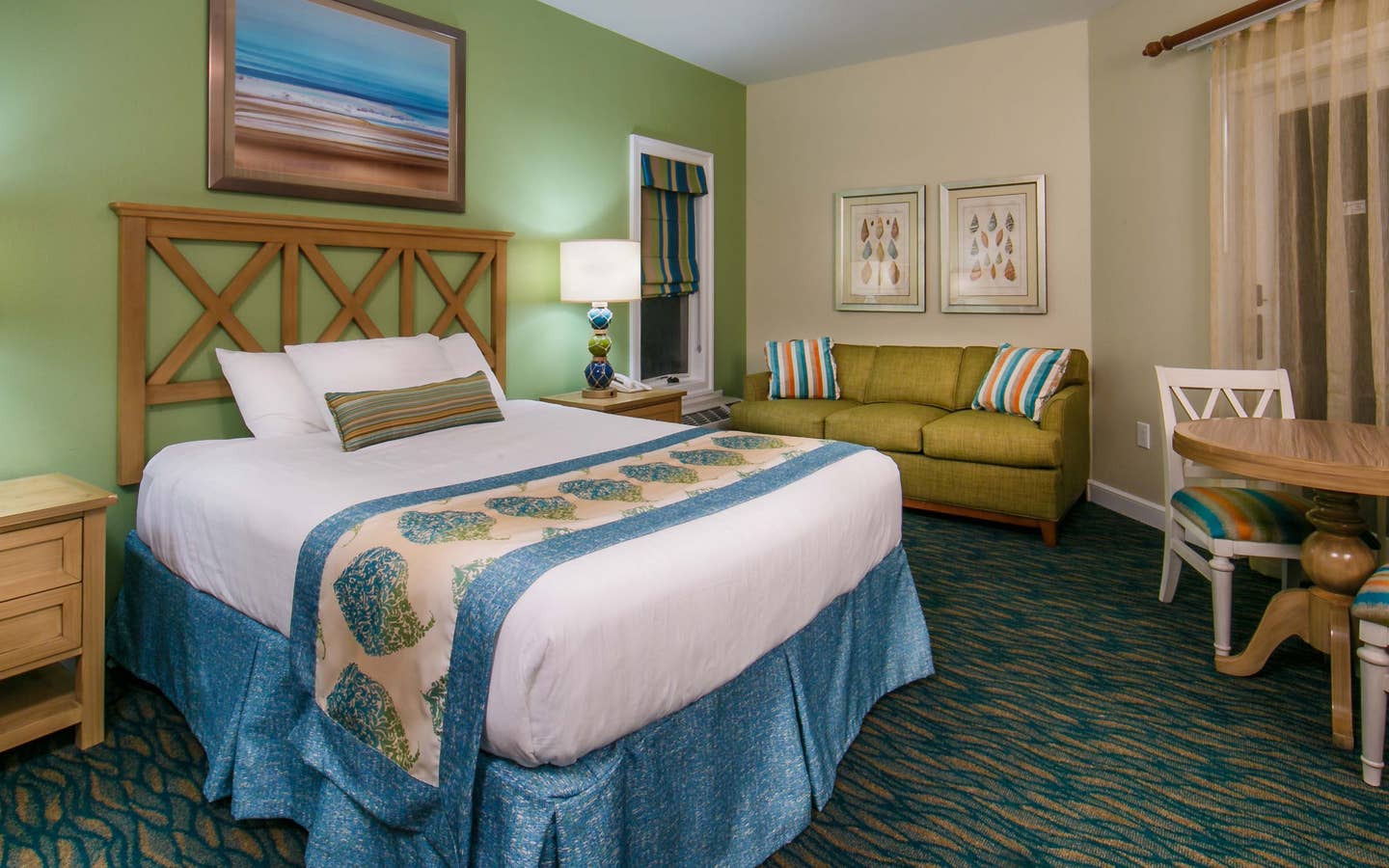 Studio room with a bed, couch and sitting area at South Beach Resort in Myrtle Beach, South Carolina.