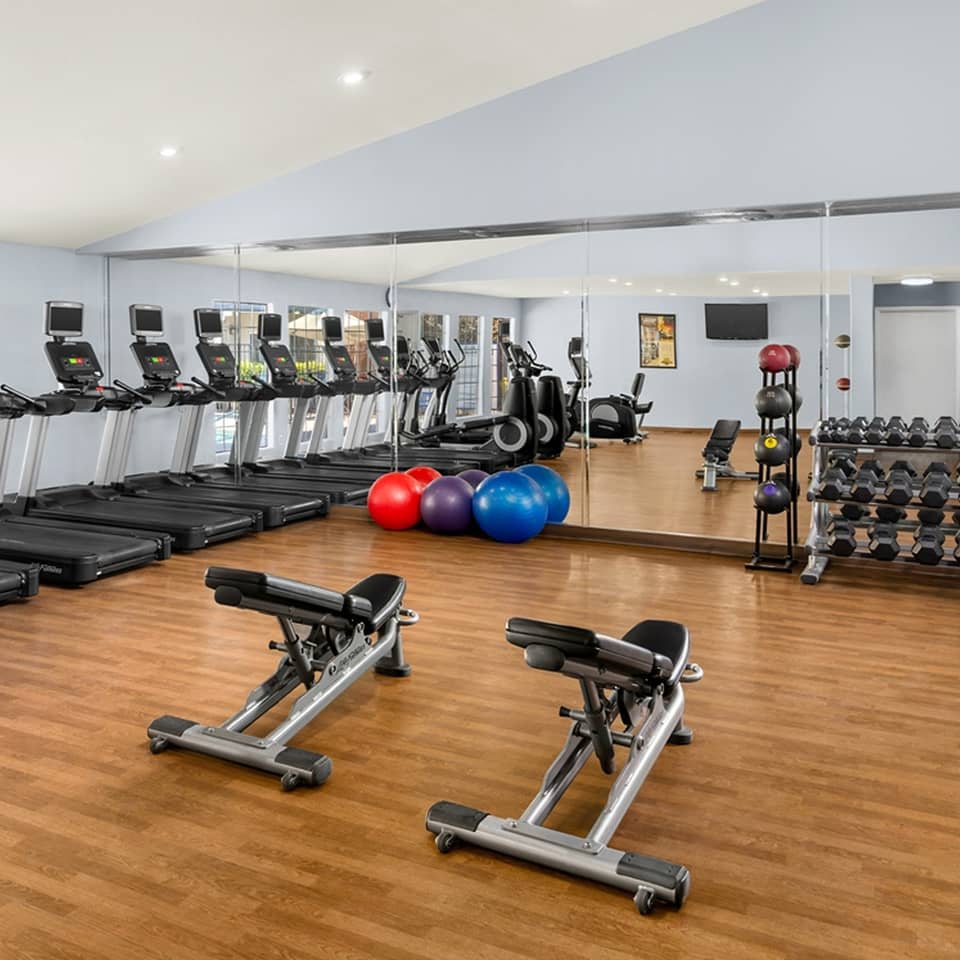 Man working out with weight ball in fitness center at Desert Club Resort in Las Vegas, Nevada.