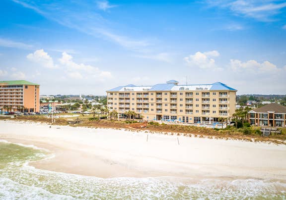 View of property building, ocean, and beach at Panama City Beach Resort.