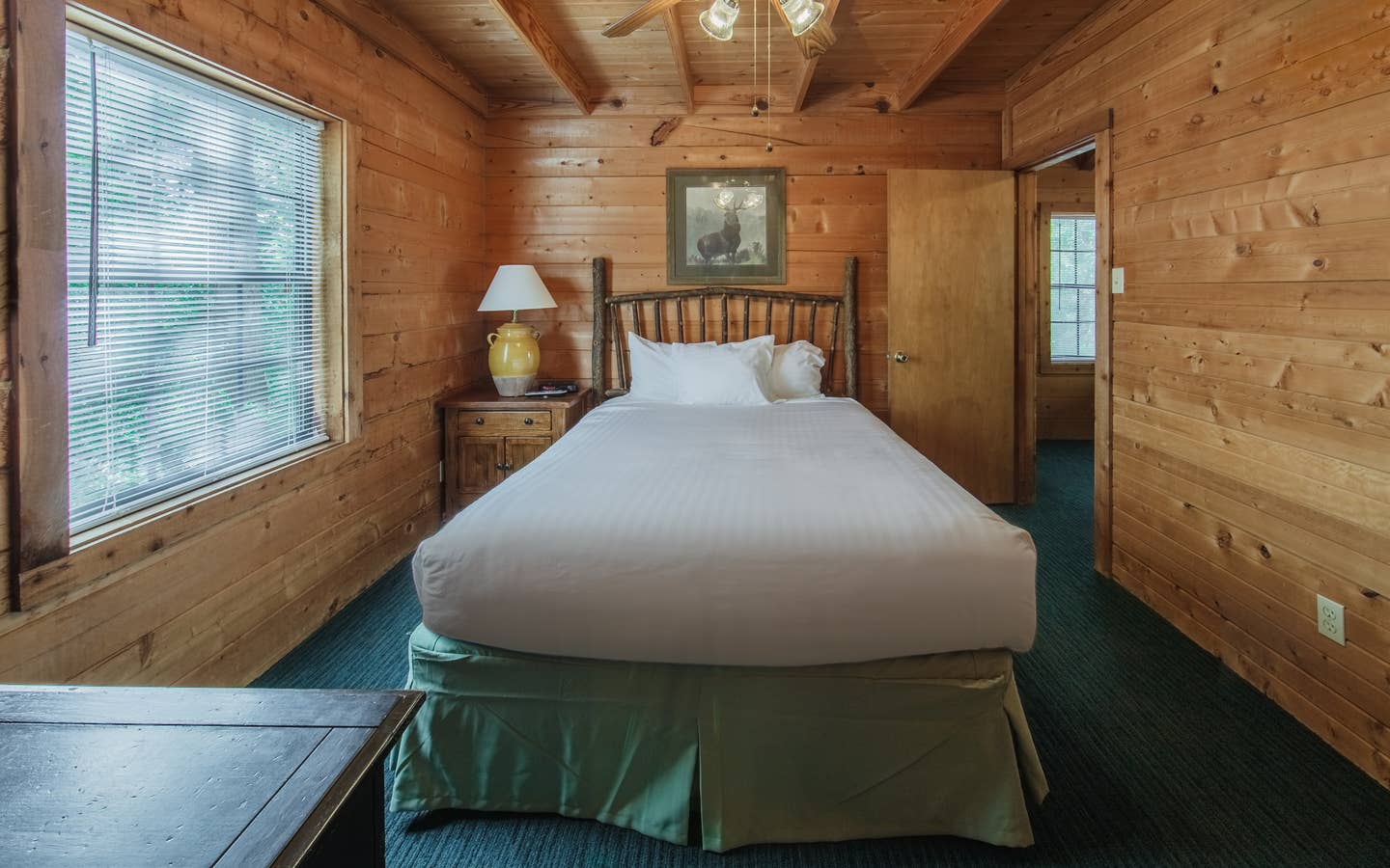 Bedroom in a one-bedroom log cabin at Holly Lake Resort in Holly Lake Ranch, Texas.